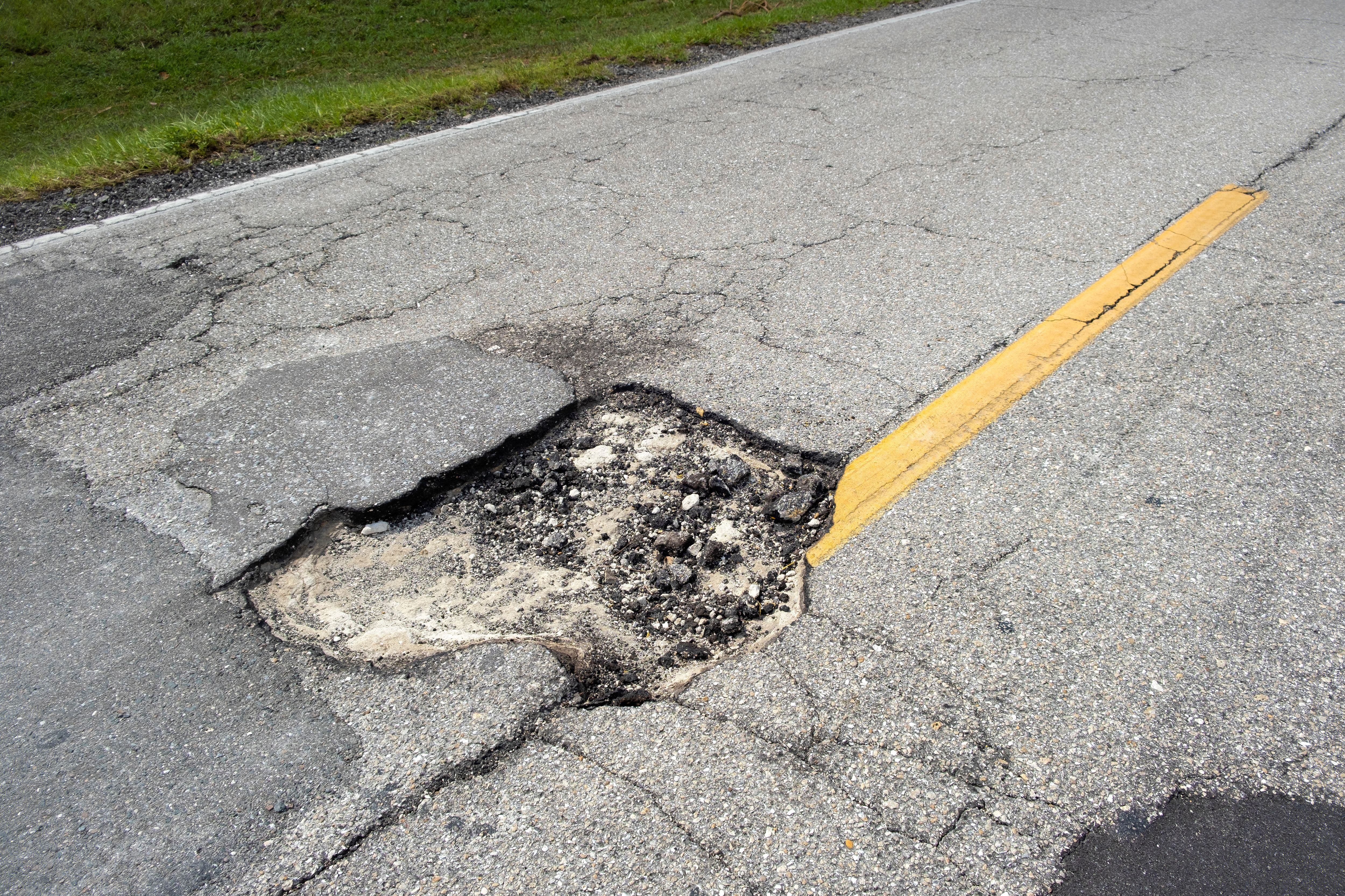 a pothole in the road demonstrating the worst highways for RVs